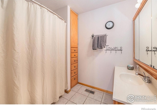 bathroom featuring tile patterned flooring and sink