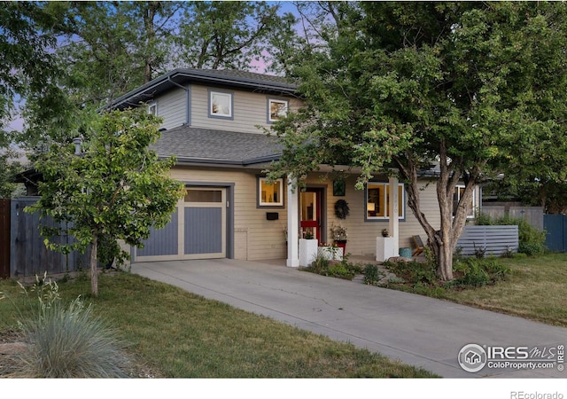 view of front of property with a front yard and a garage