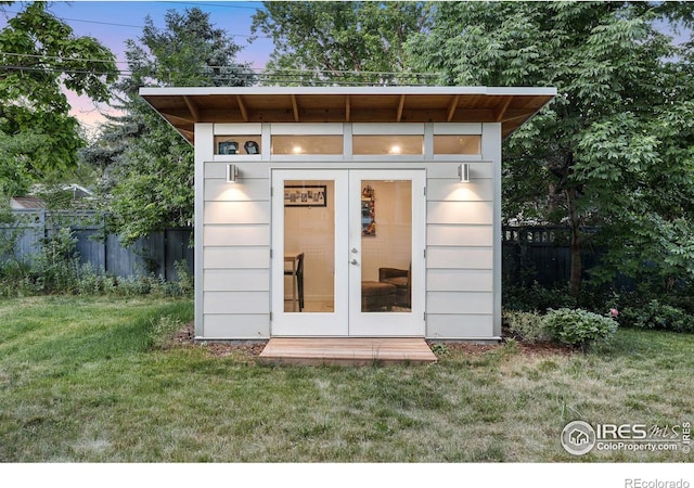 outdoor structure at dusk with a yard