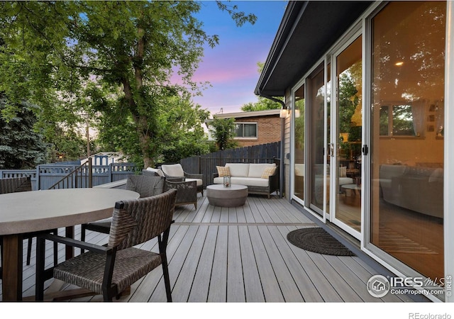 deck at dusk with an outdoor living space