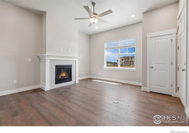 unfurnished living room featuring hardwood / wood-style flooring, a fireplace, and ceiling fan