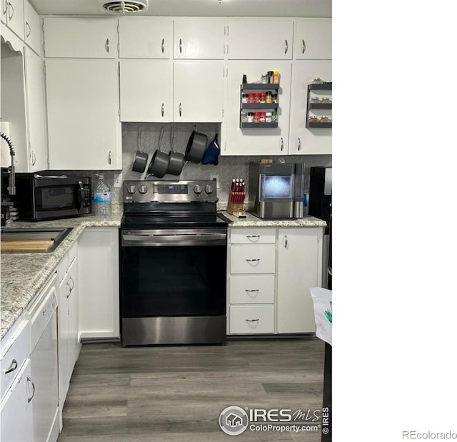 kitchen with white cabinets, dishwasher, stainless steel electric range oven, dark wood-type flooring, and a sink