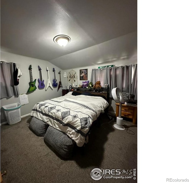 carpeted bedroom featuring lofted ceiling