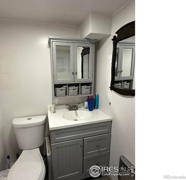 half bath featuring toilet and vanity