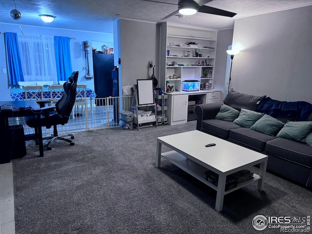 living area featuring built in features, carpet, ceiling fan, and a textured ceiling