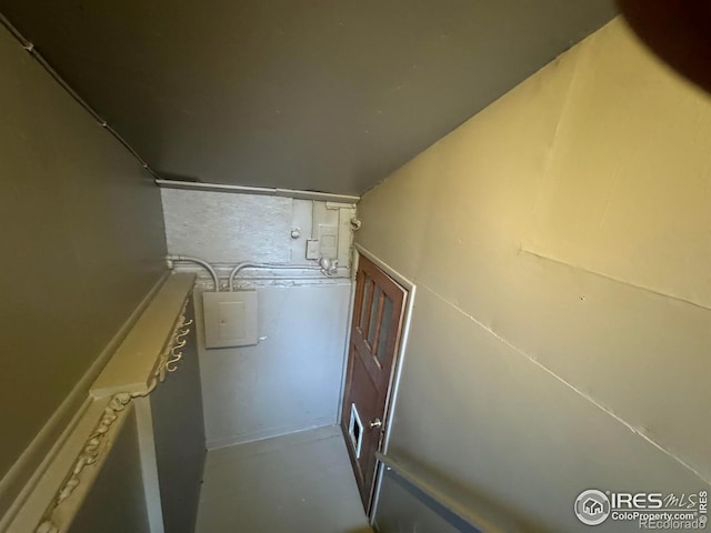 stairs featuring concrete flooring