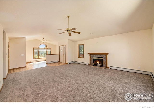 unfurnished living room featuring ceiling fan, a fireplace, a baseboard radiator, and vaulted ceiling