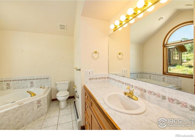 bathroom with tile patterned floors, tiled bath, lofted ceiling, toilet, and vanity