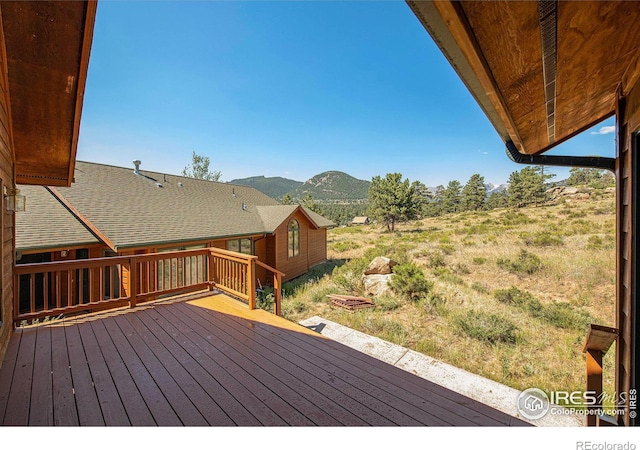 wooden deck with a mountain view