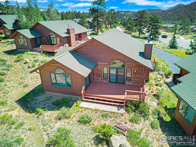 view of front facade featuring a deck with mountain view