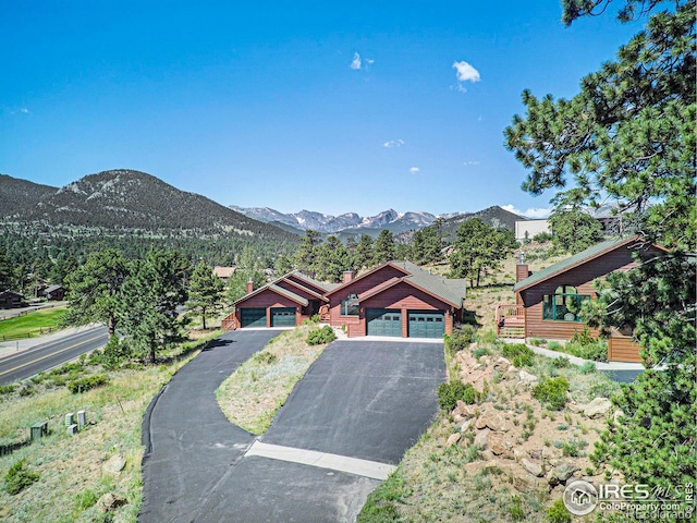 view of front facade featuring a mountain view and a garage