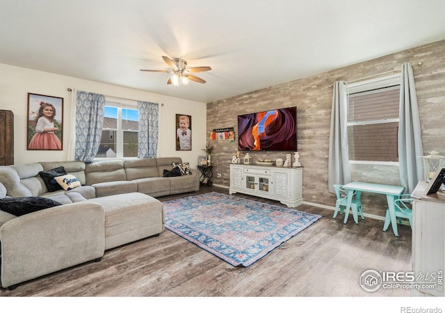 living room with wood-type flooring and ceiling fan