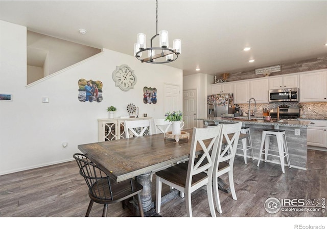 dining space featuring dark hardwood / wood-style floors and a chandelier