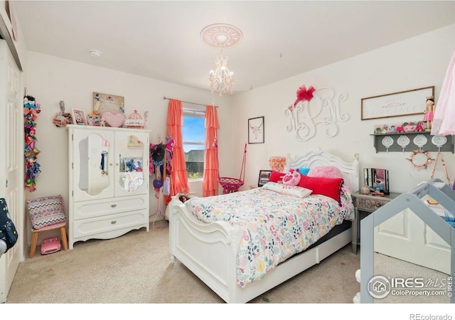 bedroom featuring light carpet and an inviting chandelier