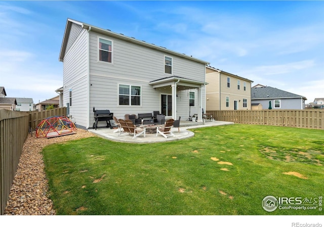 rear view of house with a patio area, a yard, and an outdoor living space with a fire pit