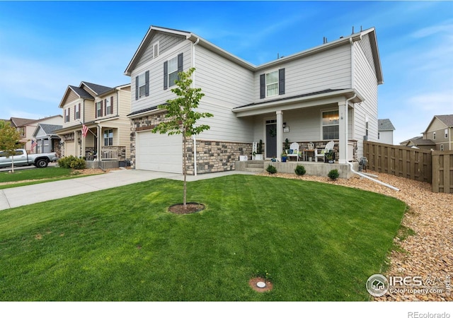 view of front of house with a front yard, a garage, and covered porch