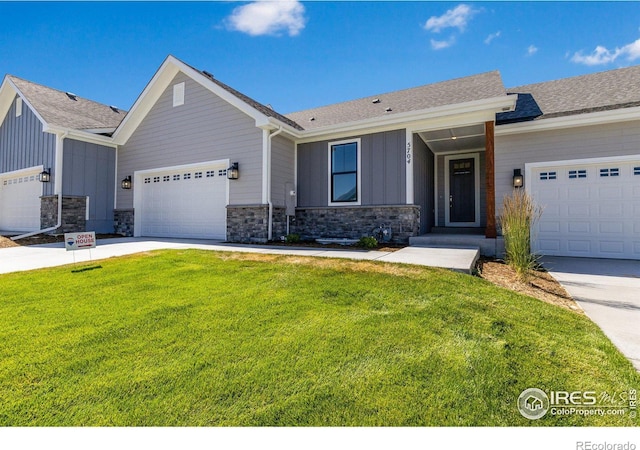 view of front of home with a front yard and a garage