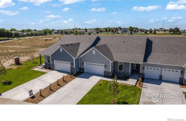 view of front of property with a front yard and a garage