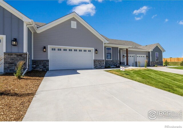 view of front of home with a front yard and a garage