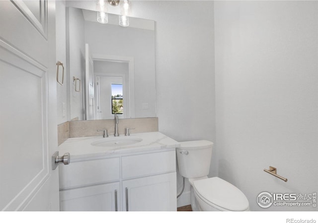 bathroom featuring toilet and vanity