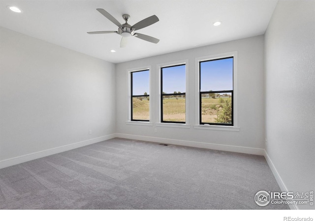 carpeted empty room featuring ceiling fan