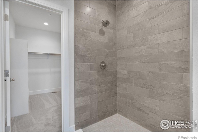 bathroom with tiled shower