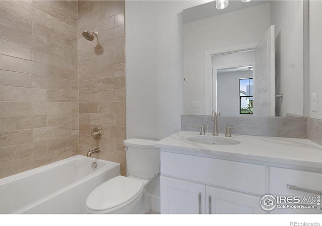 full bathroom with toilet, vanity, and tiled shower / bath combo