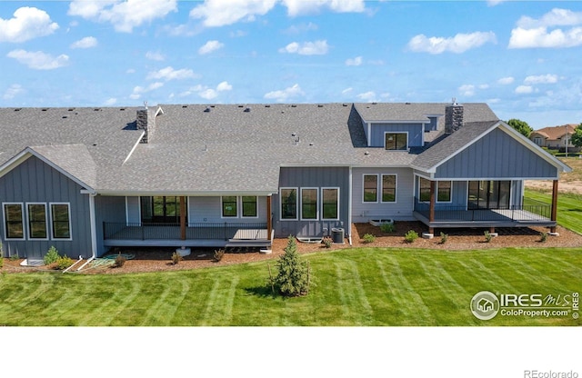 back of house with a yard and central AC