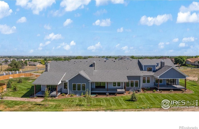 exterior space with a deck and a lawn