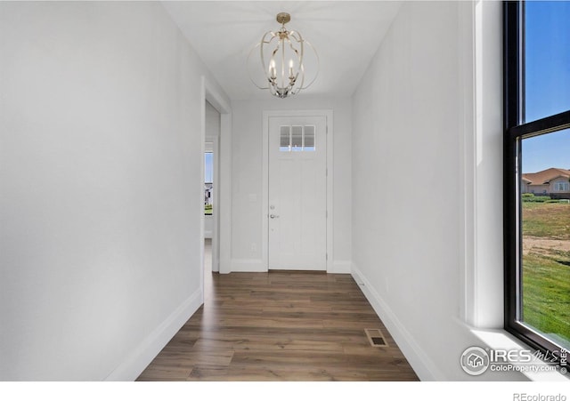 entrance foyer with a notable chandelier and dark hardwood / wood-style floors