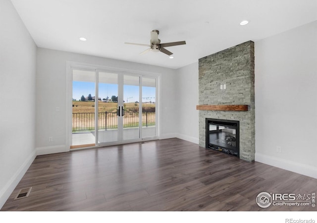 unfurnished living room with dark hardwood / wood-style flooring, a fireplace, and ceiling fan