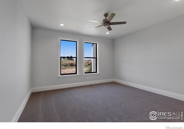 carpeted spare room featuring ceiling fan