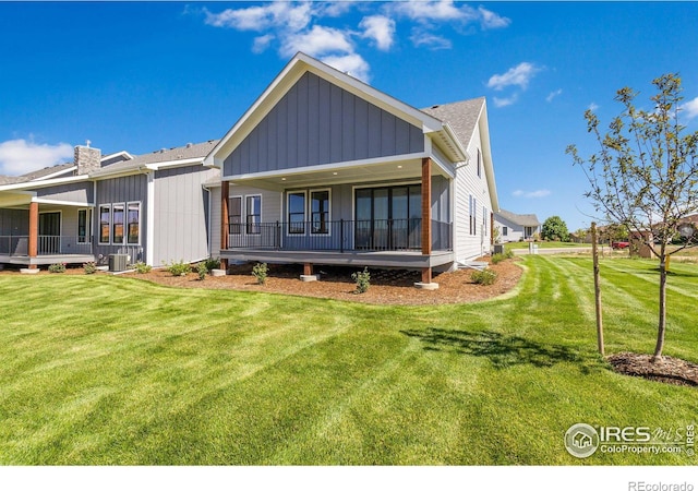 back of property with cooling unit and a lawn