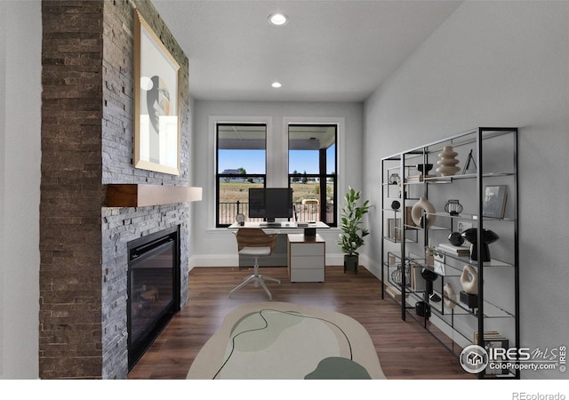 office featuring dark hardwood / wood-style flooring and a fireplace