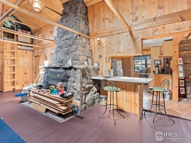 interior space featuring hardwood / wood-style floors, beam ceiling, wood ceiling, and high vaulted ceiling