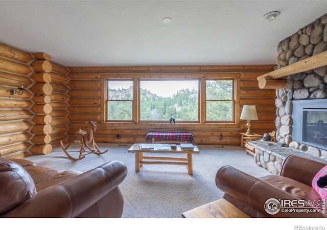 carpeted living room with a stone fireplace and log walls