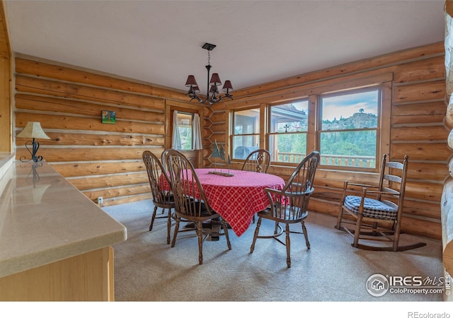 dining room with carpet floors, log walls, and a chandelier