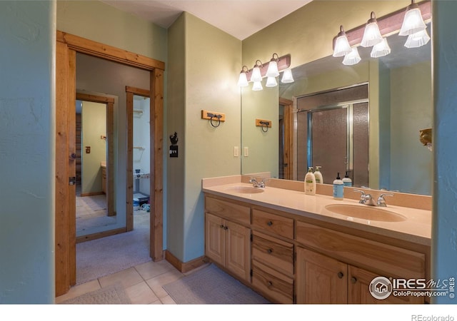 bathroom with double vanity, toilet, and tile patterned floors