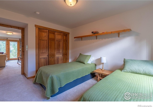 carpeted bedroom with a closet