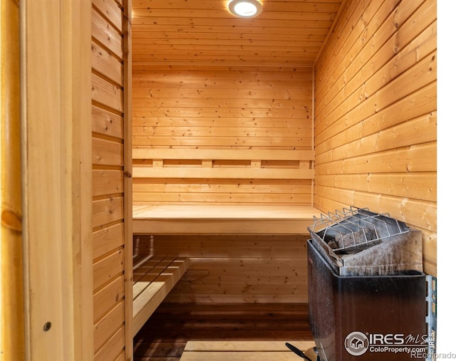 view of sauna / steam room with wood walls and hardwood / wood-style flooring