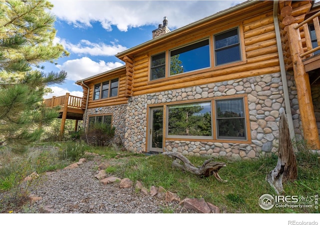 back of house with a wooden deck