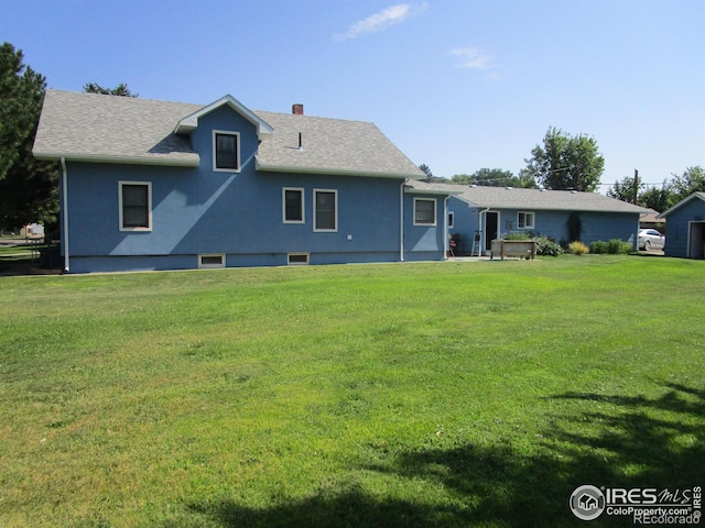 back of property featuring a lawn