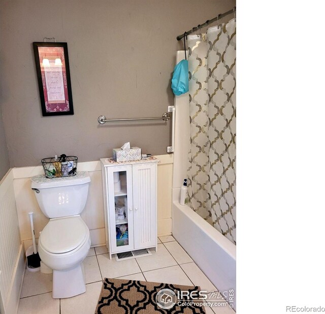 bathroom with toilet, tile patterned floors, and shower / bath combo