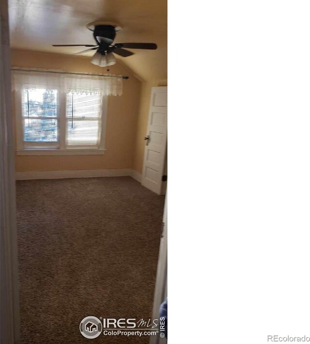 carpeted spare room with lofted ceiling and ceiling fan