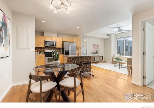 dining room with light hardwood / wood-style flooring and ceiling fan