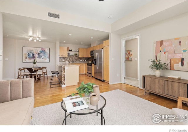 living room with light hardwood / wood-style flooring