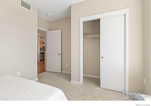 carpeted bedroom featuring a closet