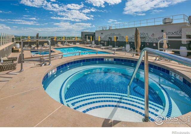 view of pool featuring a community hot tub