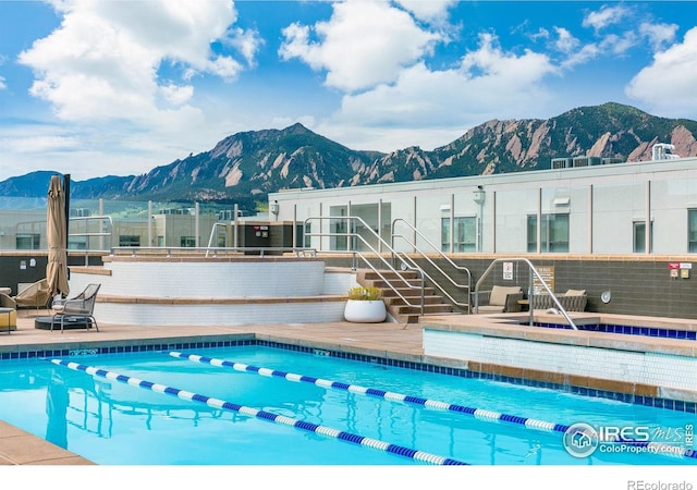 view of swimming pool with a mountain view