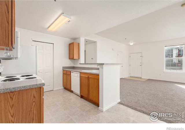 2990 W C St Unit 103, Greeley, CO 80631 - kitchen with white dishwasher, open floor plan, light carpet, a sink, and a peninsula